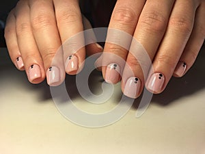 fashionable light manicure and points on short nudity