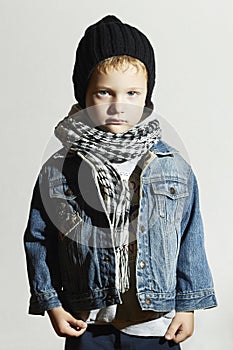 Fashionable little boy in scarf and jeans.winter style.fashion kids.child in black cap