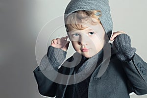 Fashionable Little Boy. Stylish Handsome Kid. Fashion Children. in suit, sweater and cap