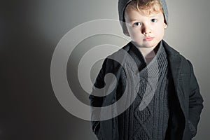 Fashionable Little Boy.Stylish Handsome Kid. Fashion Children. in suit, sweater and cap