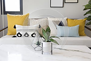 Fashionable living room interior with yellow and blue accents.