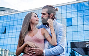 Fashionable loving young couple embracing at city street enjoying relations together, love and romance