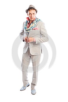 Fashionable male model wearing grey suit, scarf and hat