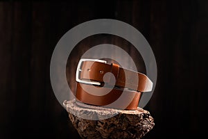 Fashionable men leather belt on a wooden