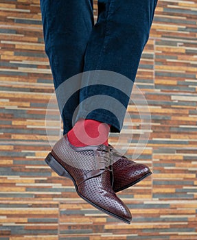 Fashionable men`s shoes with beautiful feet in socks