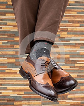 Fashionable men`s shoes with beautiful feet in socks
