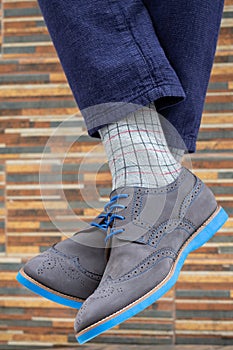 Fashionable men`s shoes with beautiful feet in socks