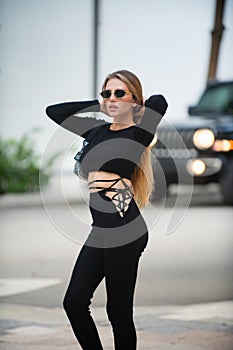Fashionable model. Beautiful girl in trendy summer clothes. Sexy model in the street. High fashion model in black dress