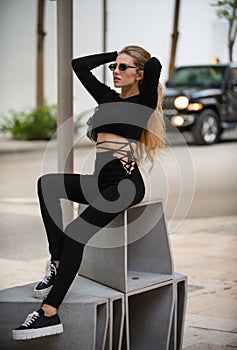 Fashionable model. Sensual woman, fashion model in style casual clothes dress posing on street outdoor. Summer