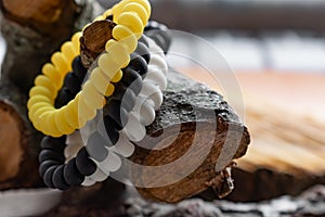 Fashionable and modern elastic hair springs. Different colors of stretching hand bracelets on wooden background,