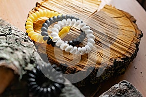 Fashionable and modern elastic hair springs. Different colors of stretching hand bracelets on wooden background,