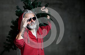 Fashionable modern millionaire Santa old man in red fashion hoodie celebrate Christmas