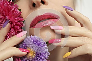 Fashionable multi-colored makeup and manicure on long nails