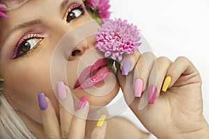 Fashionable multi-colored makeup and manicure on long nails