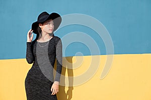 Fashionable oriental woman posing in a black dress