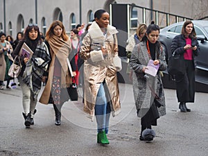 MILAN - FEBRUARY 22, 2018: Fashionable people walking in the street after LES COPINS fashion show