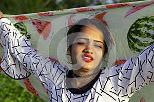 Fashionable portrait of an indian girl model with Colorful scarf waving from top of head, joy, happy , holidays