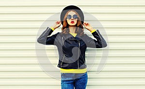 Fashionable portrait stylish young woman model posing wearing a black rock style jacket on white background