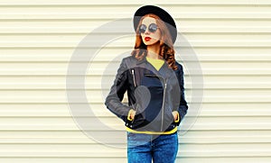 Fashionable portrait stylish young woman model posing wearing a black rock style jacket on white background