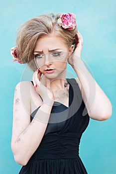 Fashionable portrait of a tearful girl with dry flowers. Retro s