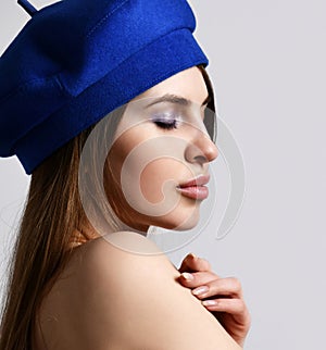 Fashionable pretty modern young french woman with sexy lips in a stylish blue elegant beret hat closeup portrait