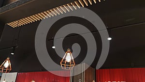 Fashionable and stylish black ceiling with chandeliers in a shopping center, modern