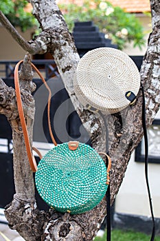 Fashionable stylish rattan bag outside. Tropical island of Bali, Indonesia. Rattan handbag.