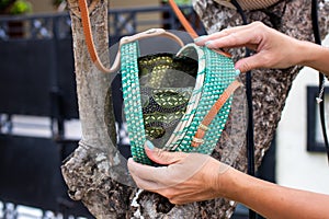 Fashionable stylish rattan bag outside. Tropical island of Bali, Indonesia. Rattan handbag.