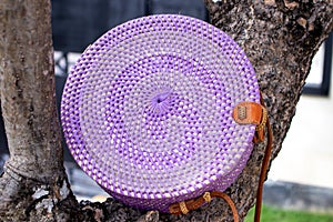 Fashionable stylish rattan bag outside. Tropical island of Bali, Indonesia. Rattan handbag.