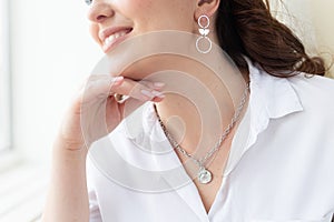 Fashionable and stylish woman in trendy jewelry big earrings . Fashion look beauty and style. Natural makeup and easy