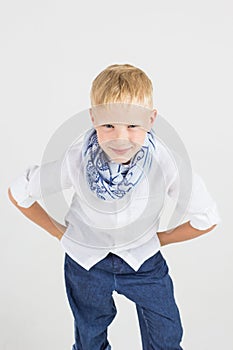 Fashionable teenager boy in blue scarf smiles