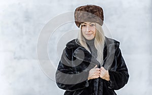 Fashionable trend. Woman in fur fat and faux fur coat photo