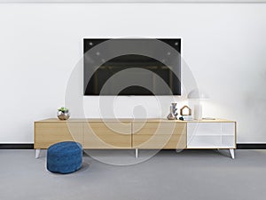 Fashionable tv unit with a wooden chest of drawers and a tv set over a white wall