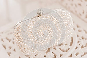 Fashionable wedding accessory. Pearl clutch handbag for an elegant bride