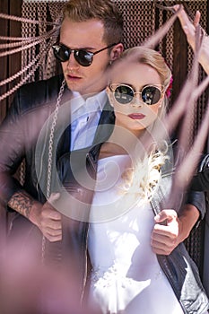 Fashionable wedding couple. Bride and Groom. Outdoor portrait