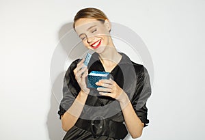 Fashionable woman in black dress and red lips with stylish gift box