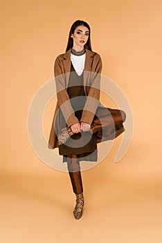 fashionable woman in brown coat and
