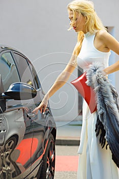 Fashionable woman opening car