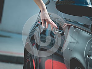 Fashionable woman opening car