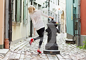 Fashionable woman wearing red high heel shoes in old town