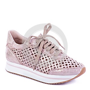Fashionable women\'s sneaker from dusty pink leather with perforation and shiny effect and white-pink-brown sole