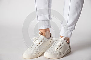 Fashionable women& x27;s white leather sneakers. Stylish shoes. Casual design. Beautiful boots for all weather conditions