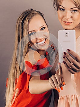 Fashionable women taking selfie