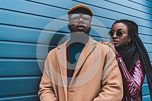 fashionable young african american couple in stylish outfit posing