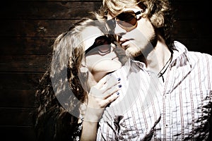 Fashionable young couple wearing sunglasses