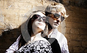 Fashionable young couple wearing sunglasses