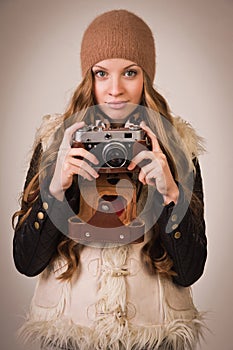 Fashionable young girl with old camera