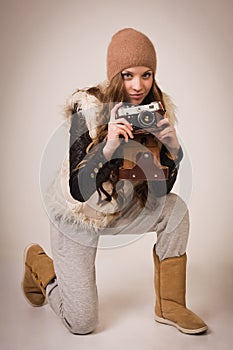 Fashionable young girl with old camera