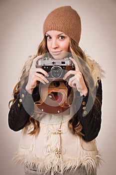 Fashionable young girl with old camera