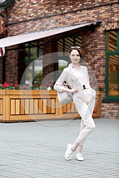 Fashionable young girl posing in the street